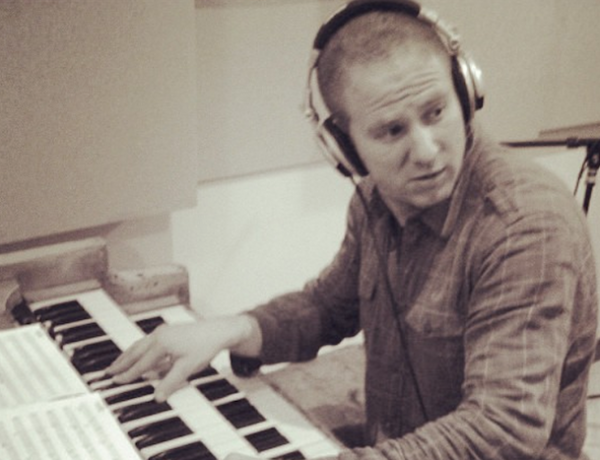keyboardist with headphones in the studio