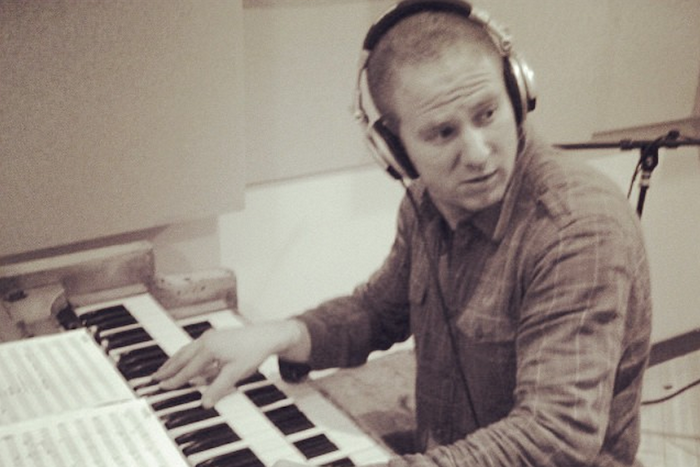 keyboardist with headphones in the studio