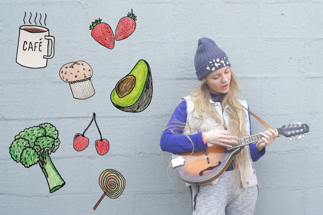 singer with ukelele surrounded by foods.