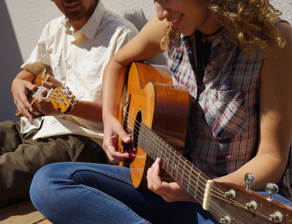 couple practicing guitar