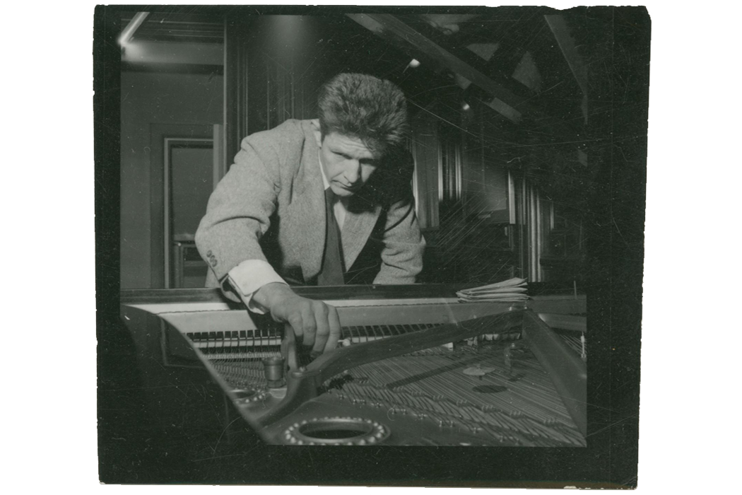 John Cage prepares a piano. Image obtained courtesy of The New York Public Library.