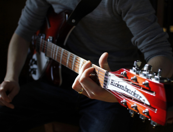 closeup hands on guitar