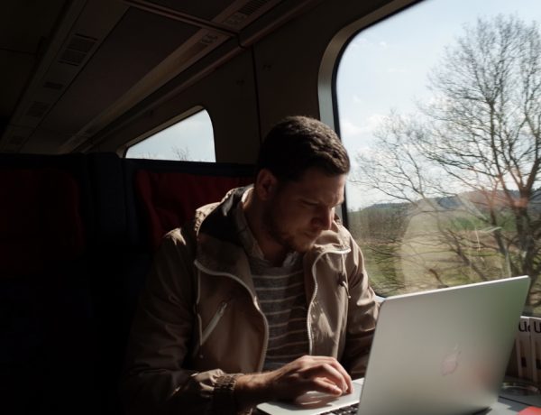 man on train writing email