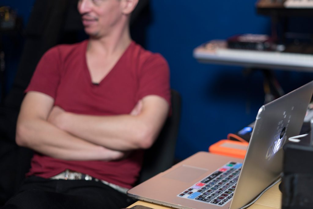 man working on laptop in studio