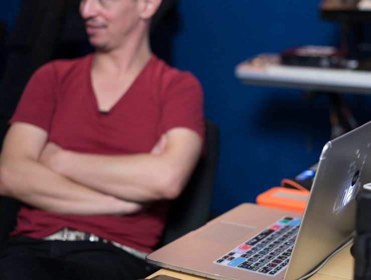 man working on laptop in studio