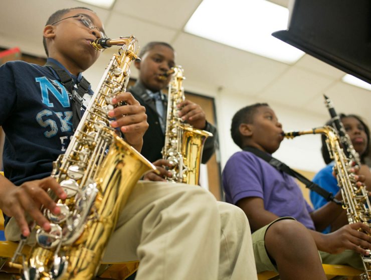 children playing saxophones in classroom