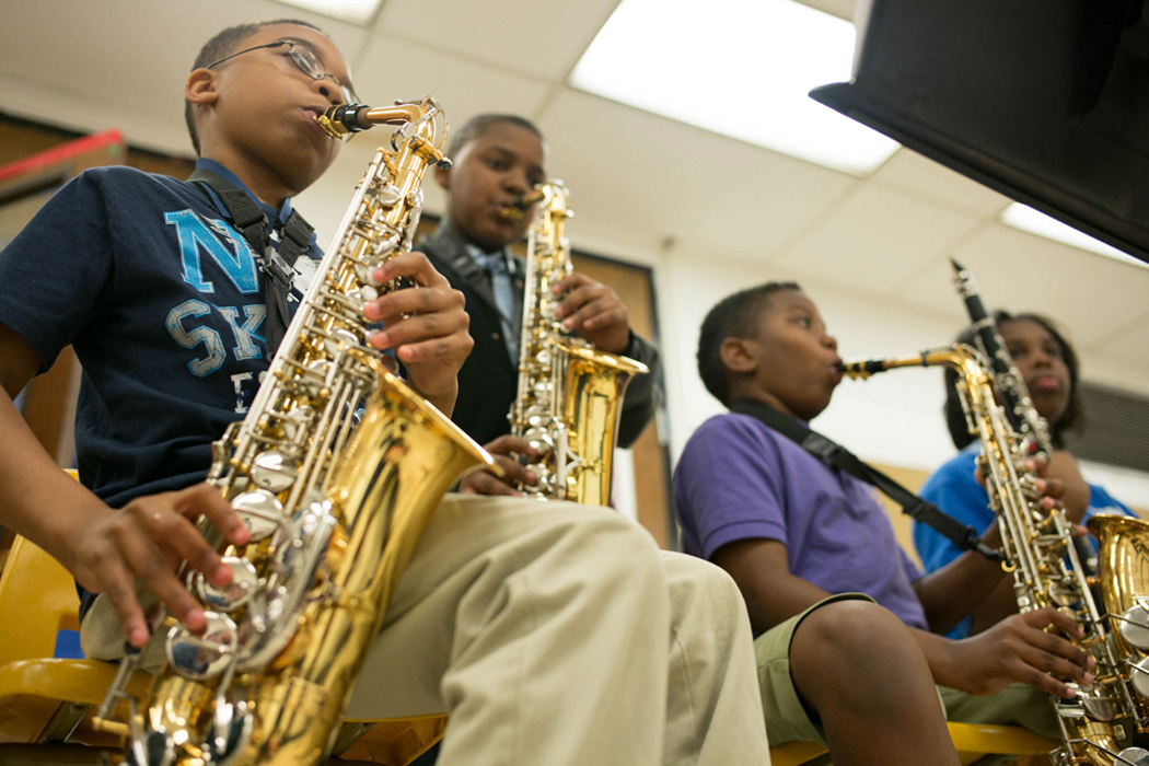 children playing saxophones in classroom