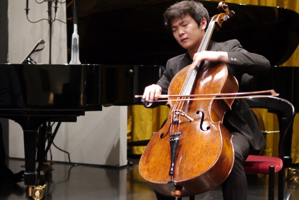 man playing cello in concert