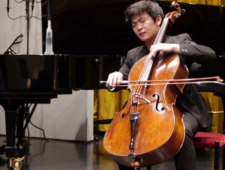 man playing cello in concert
