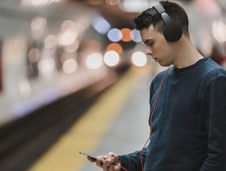 Man in subway listening to music on phone
