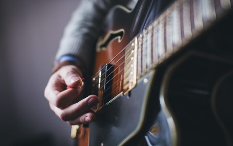 man playing guitar closeup