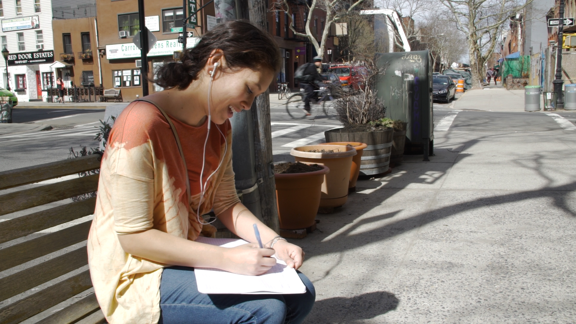 woman on the street writing lyrics