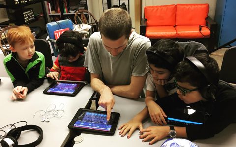 Children working with a tech coach