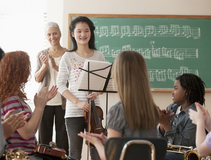 music student in classroom performing for classmates