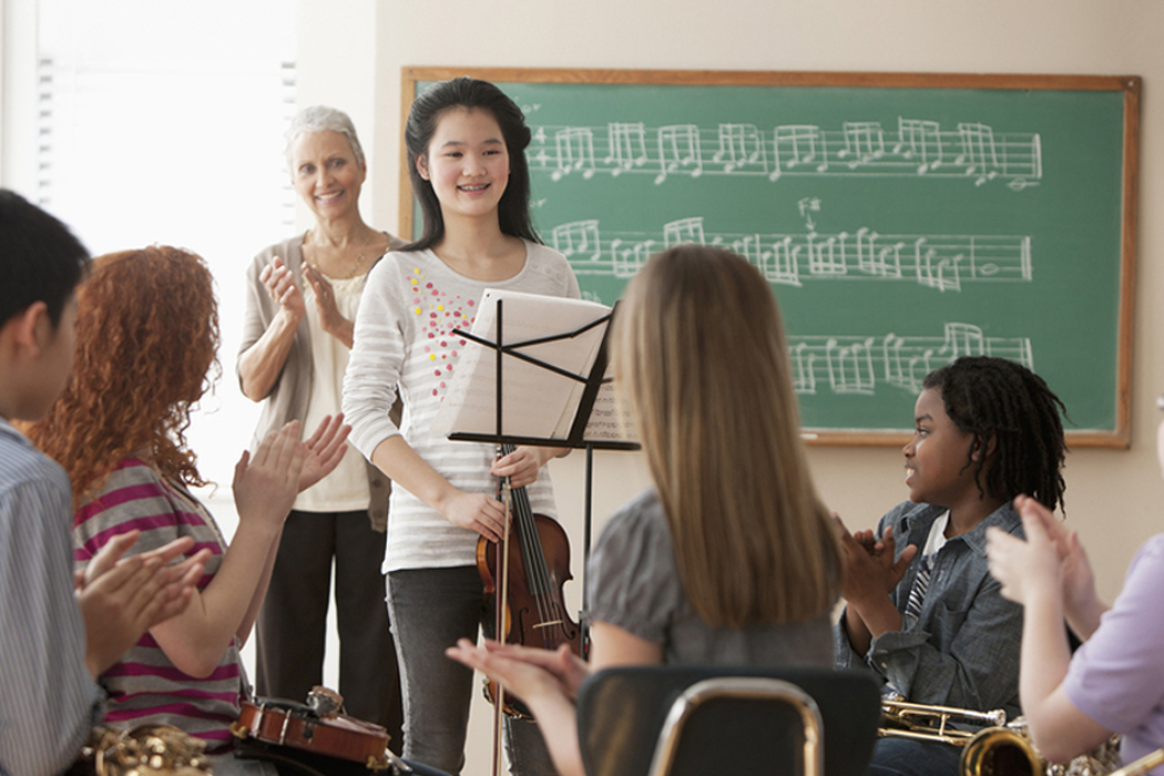 music student in classroom performing for classmates