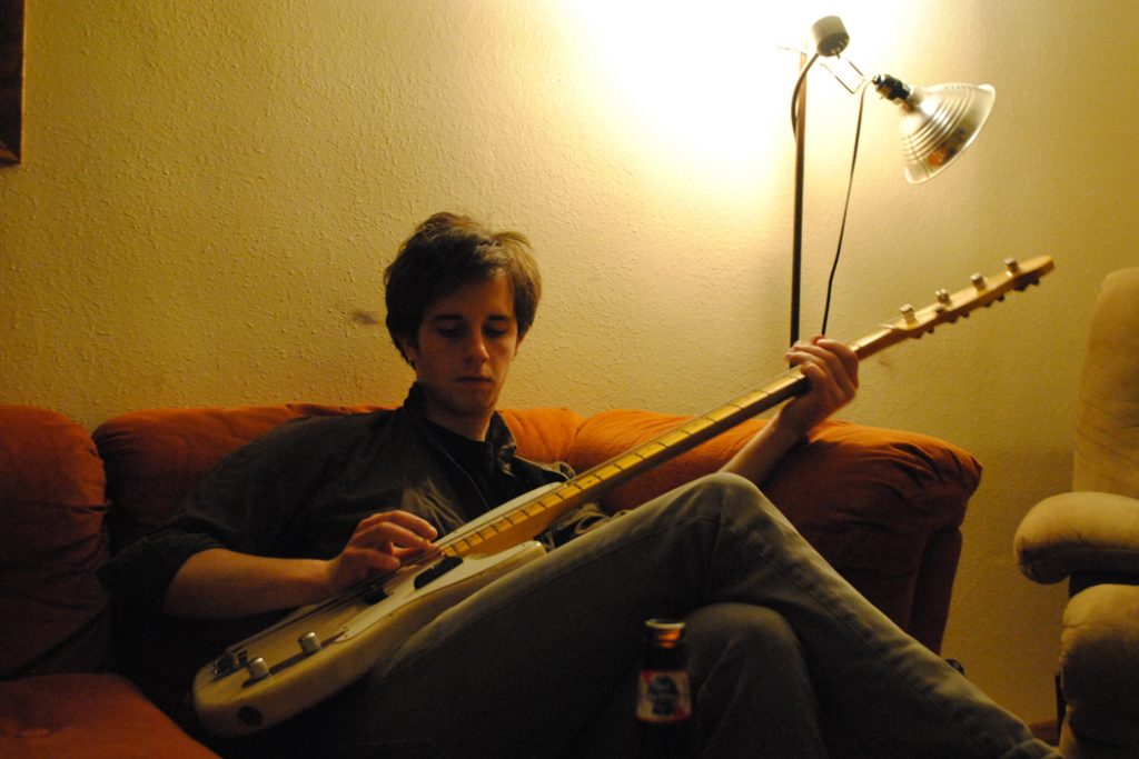 man practicing guitar backstage
