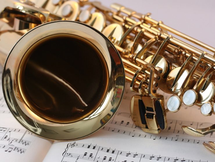 closeup of saxophone on sheet music