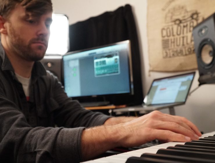 man playing keyboard in studio