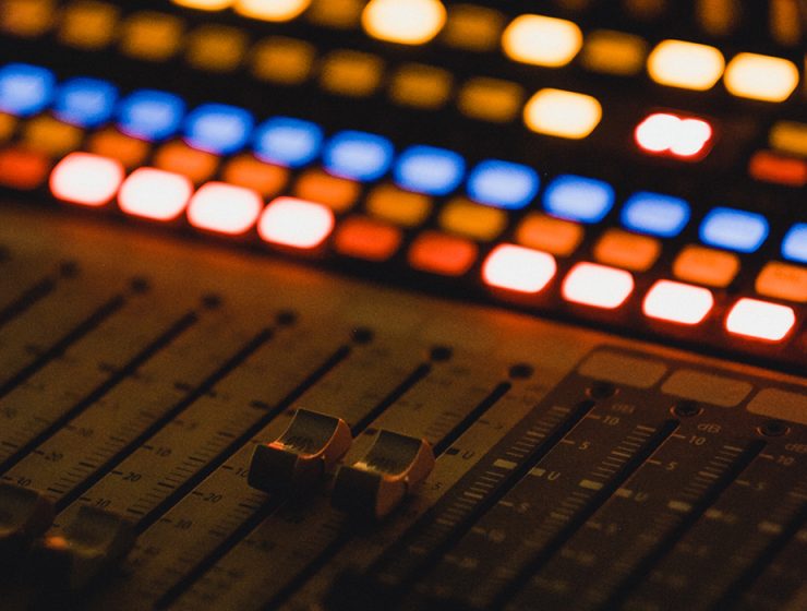 closeup of mixing board with lights on
