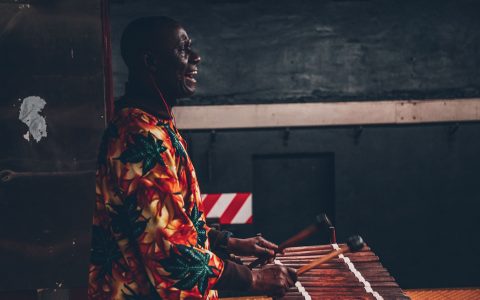 Man in robe playing marimba