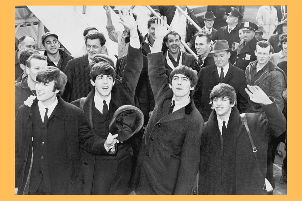 The Beatles waiving to a crowd