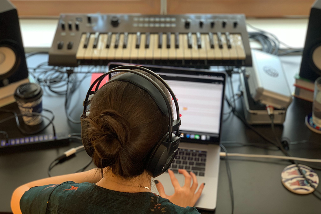 overhead view of girl producing music on laptop