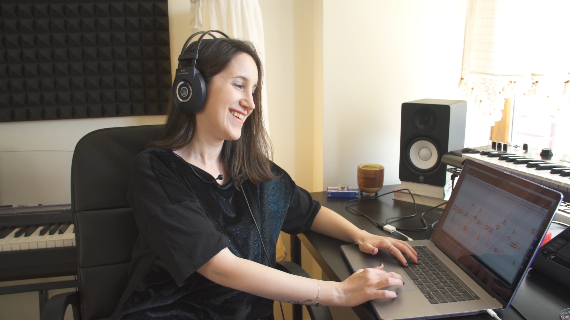 woman producing music on laptop