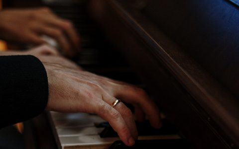 closeup hands on piano