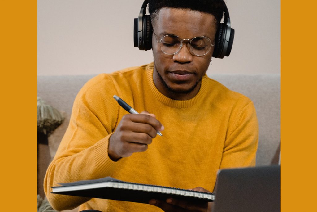 man writing music