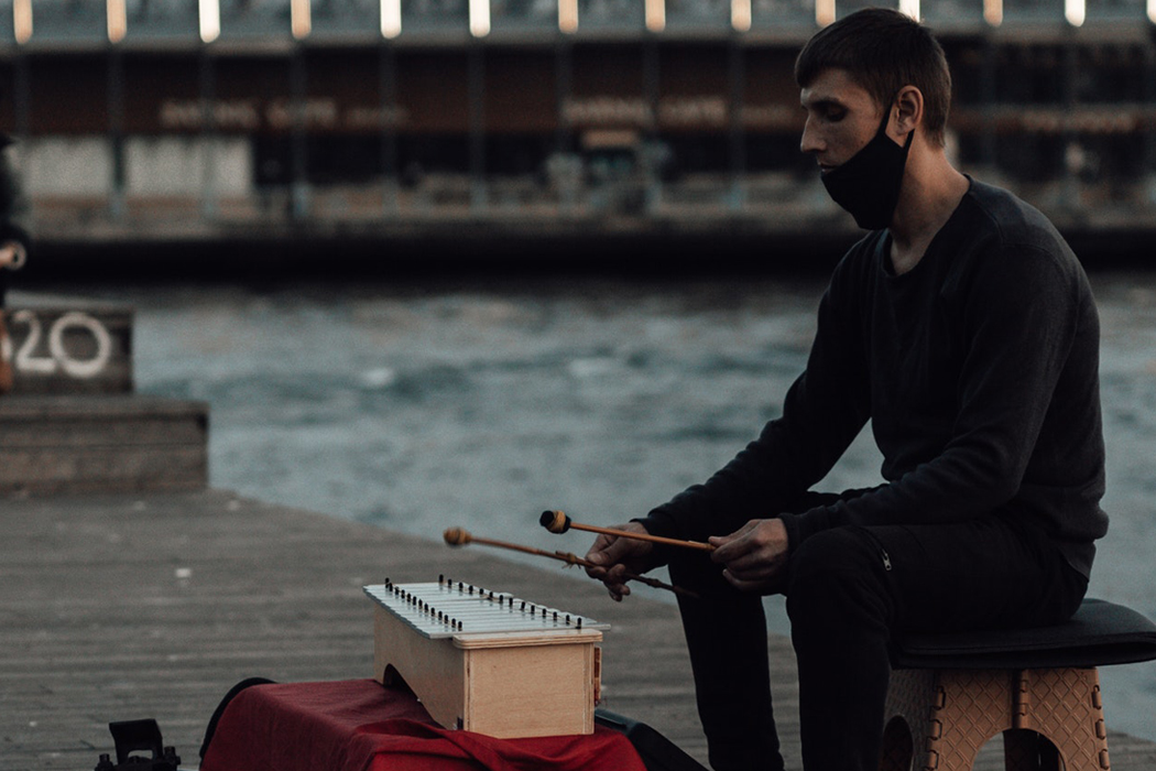 man playing music with mask