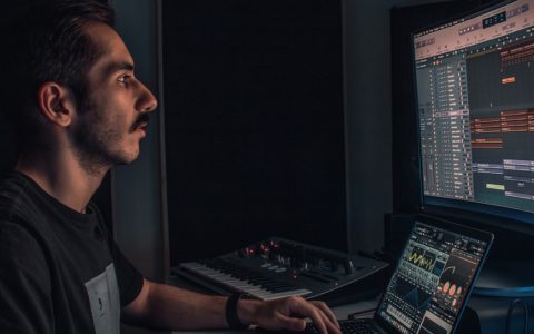 man producing music on computer