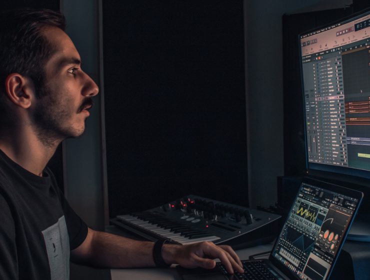 man producing music on computer