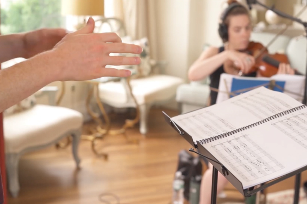 hands of conductor working with string ensemble
