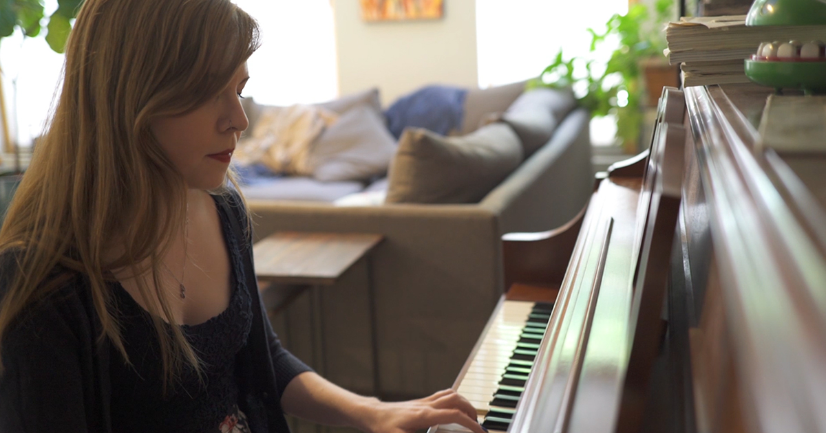 woman playing piano at home