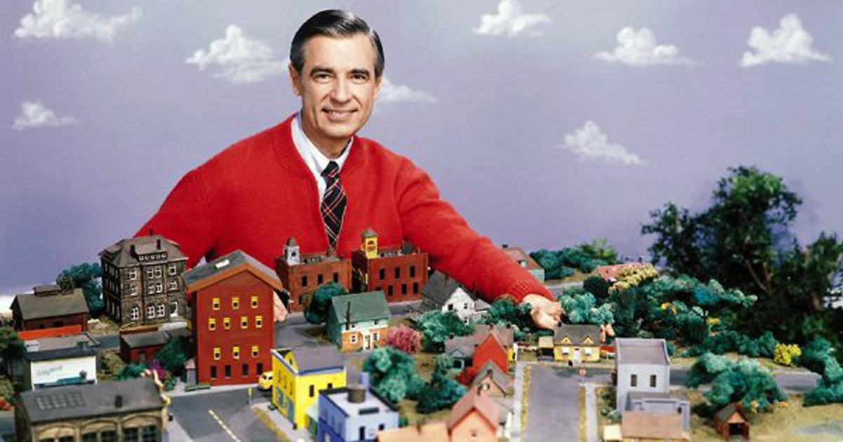 Mr. Rogers on the set of Mr. Rogers Neighborhood with a table full of model houses