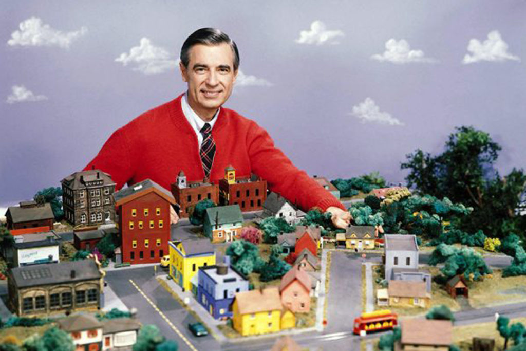 Mr. Rogers on the set of Mr. Rogers Neighborhood with a table full of model houses
