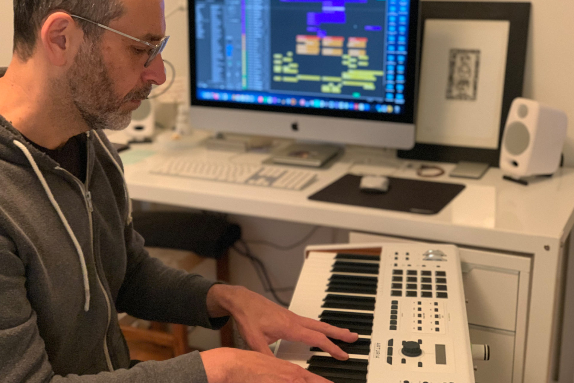 Alexis Walter Blaess plays keyboard in his home studio