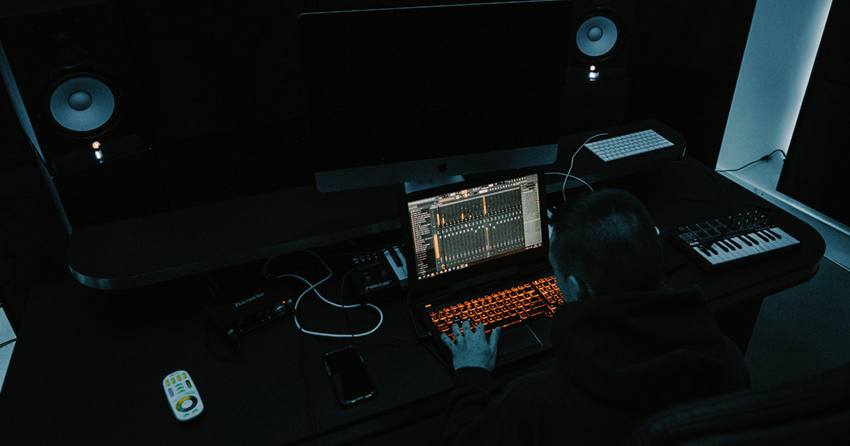 male producer making music in the dark