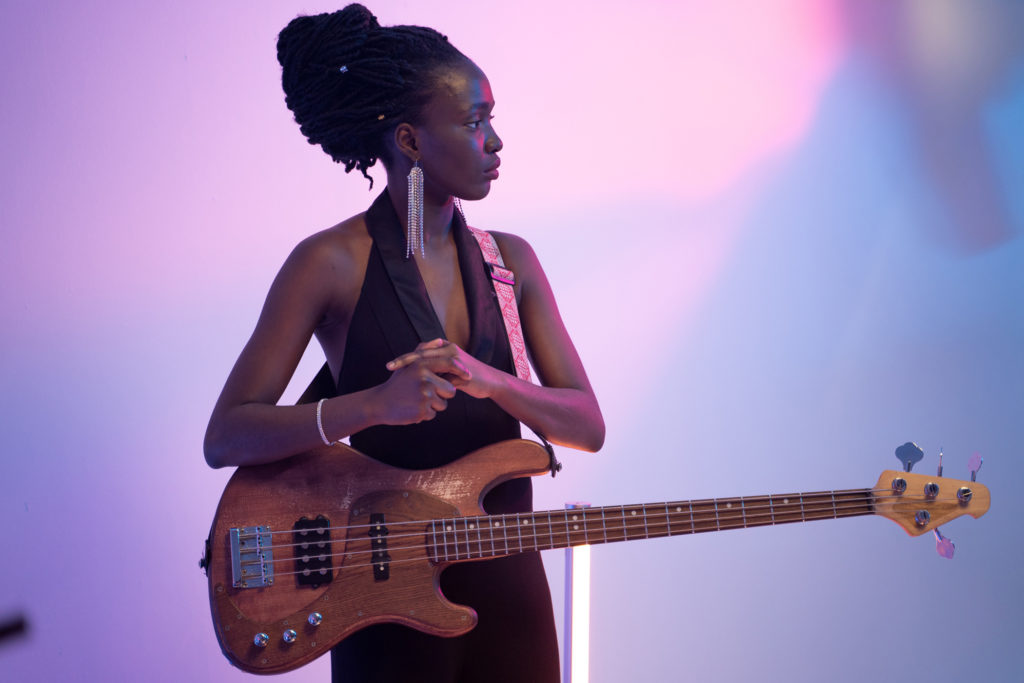 woman playing bass on stage