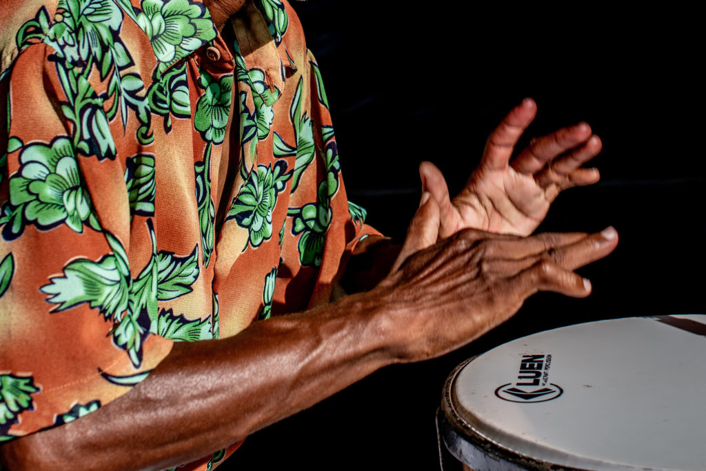 closeup of musician's hands hitting drum