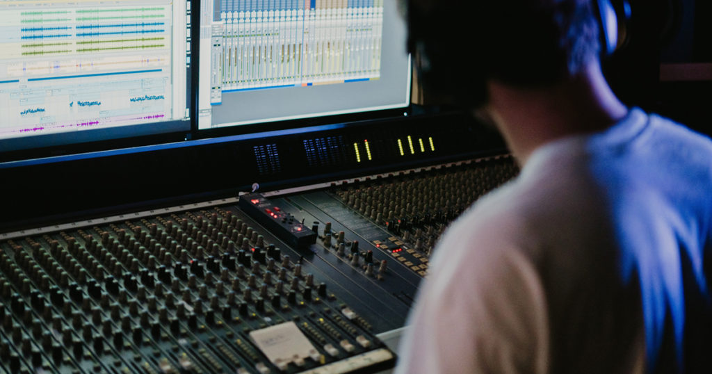 producer in studio editing audio