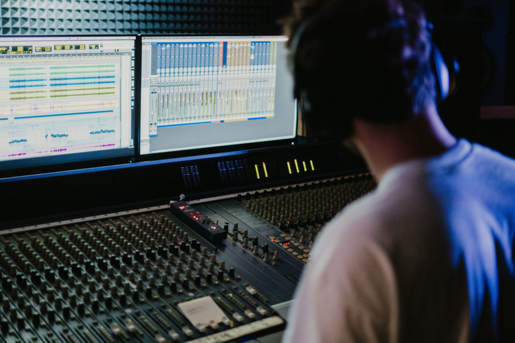 producer in studio editing audio